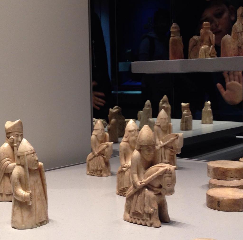 Chess pieces from the famous Lewis set in the British Museum appear to regard the people on the other side of the glass with alarm and hostility.