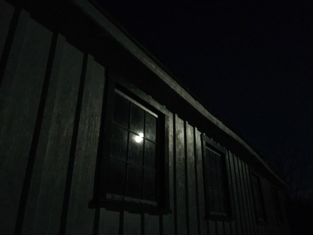 full moon reflected in a window pane
